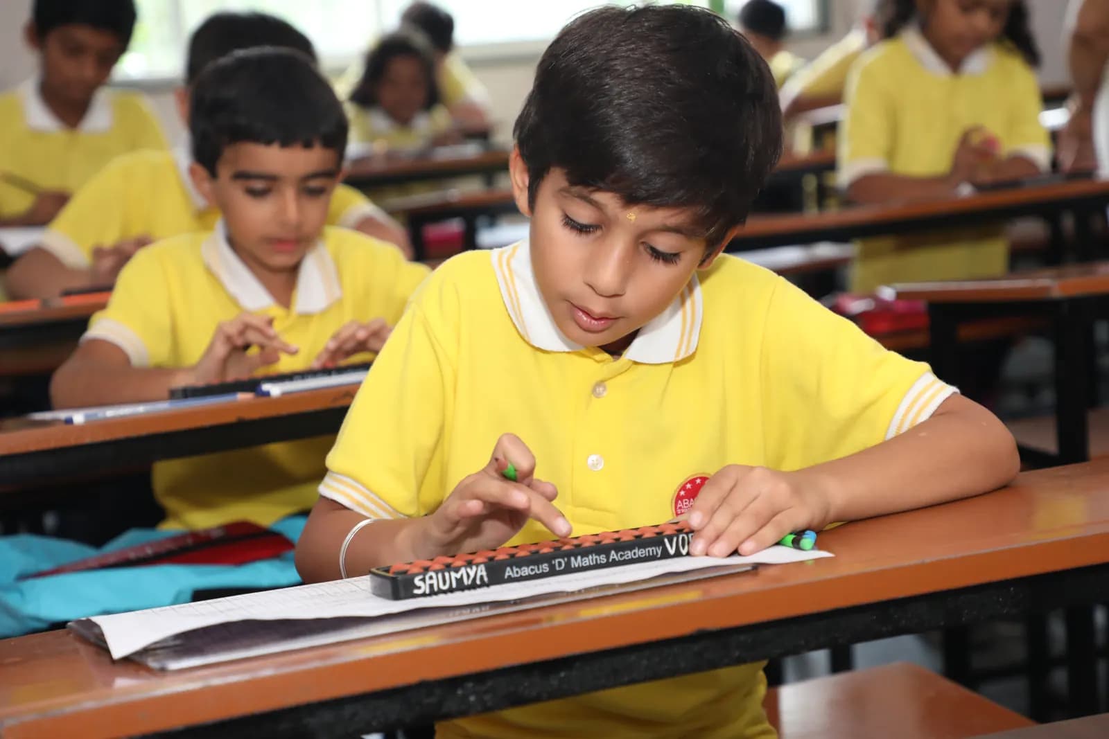 Academy student practicing rapid calculation techniques on abacus